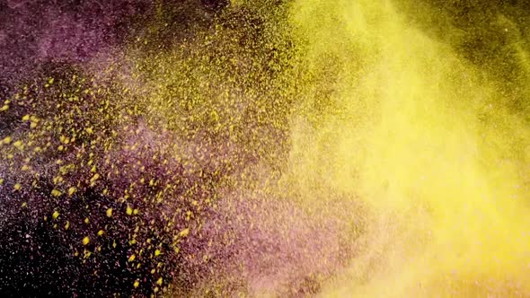 Pink and yellow powder explosion on black