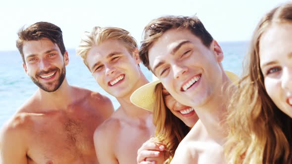 Portrait of happy friends having fun at beach