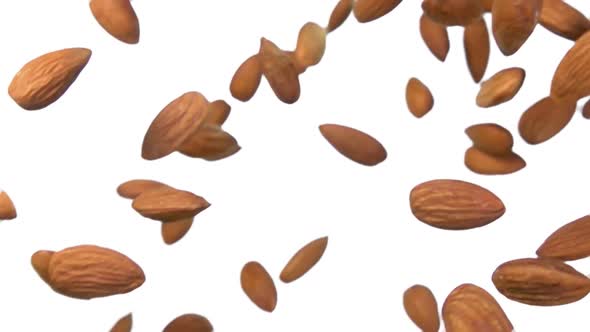 Closeup of Delicious Sweet Almonds Falling Diagonally on a White Background