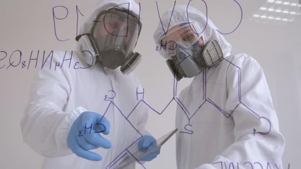 Two Doctors in Protective Suits are Investigating the New Covid19 Virus in Lab