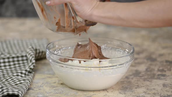 Pastry chef making chocolate cream on the kitchen