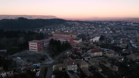 Aerial shot of a high school in Veliki Preslav, Bulgaria at sunset. Real time.