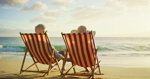 Couple Relaxing Enjoying the Sunset on the Beach