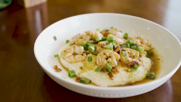 Steaming plate of fresh homemade shrimp and grits - sliding view