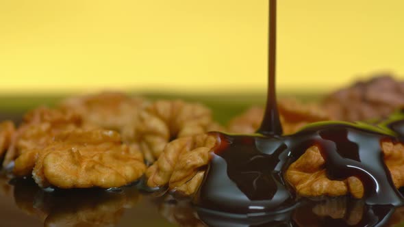 Pouring Dark Chocolate on Walnuts