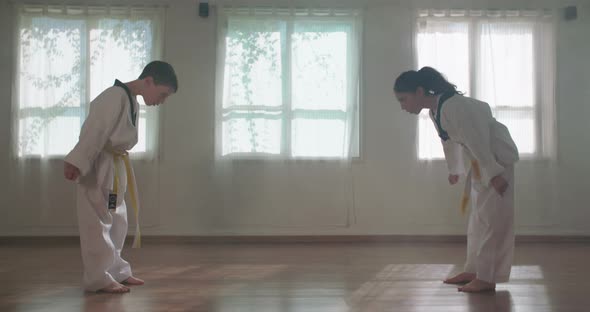 Slow motion footage of young kids practicing martial arts