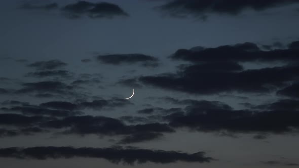 New Moon in the Evening Sky with Clouds