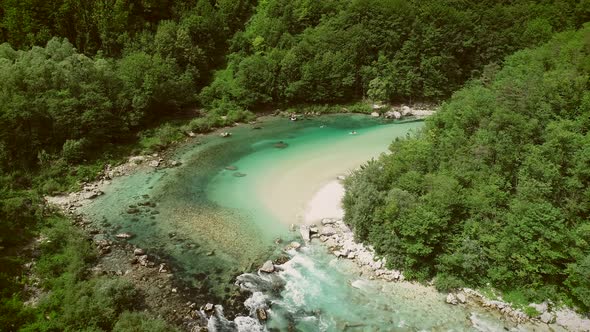 Aerial view of a group doing water rafting on the rapids at Soca River.