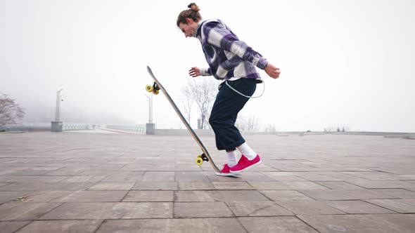 Slow Motion Trick on a Longboard Flip Turn the Board in the Air