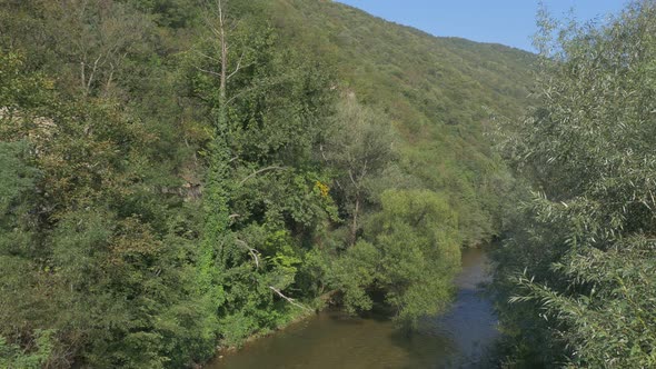 Hills over  Cerna river in  spa resort Herculane in western Romania 4K 2160p UHD footage - Cerna riv