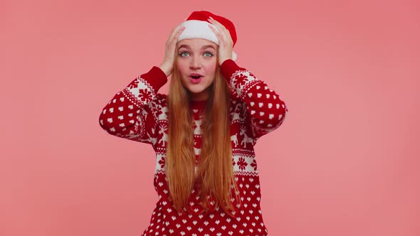 Teen Adult Girl in Christmas Hat Raising Hands in Surprise Shocked By Sudden Victory Wow Emotion