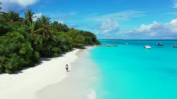 One girl tans on idyllic coast beach holiday by aqua blue sea and white sandy background of the Mald