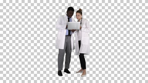 Medical staff working in front of a grey laptop while standing