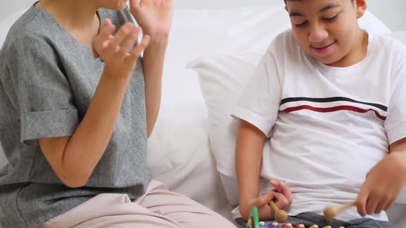 Asian mother caring for disabled son while living together at home