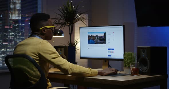 Young Man Sitting Back and Working Inside a Room