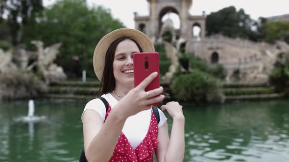 Happy Millennial Tourist Woman Taking Selfie with Smart Phone in Barcelona