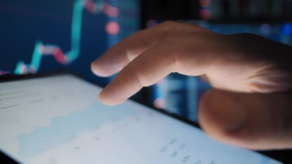 A Trader's Fingers Look at Stocks on the Market