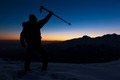 Winter hiking: man stands on a snowy ridge looking at the sunset. - PhotoDune Item for Sale