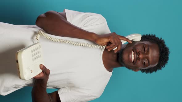 Young Adult Using Landline Telephone for Phone Call