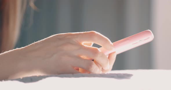 Hand of Girl Using Smartphone at Bedroom at Home Typing Message