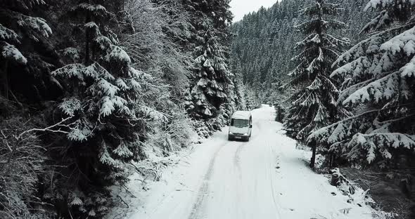 The Car Drives Through the Winter Snowy Forest Top View