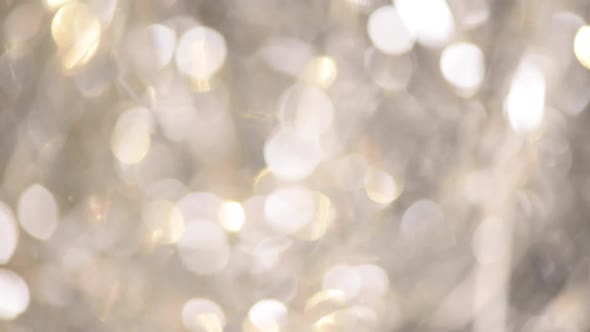 Silver Abstract Bokeh Lights. Festive Defocused Background. New Year and Christmas Concept. Greeting