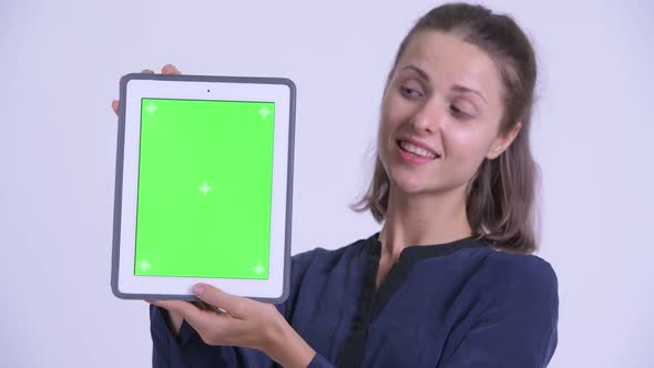 Face of Happy Young Beautiful Businesswoman Showing Digital Tablet