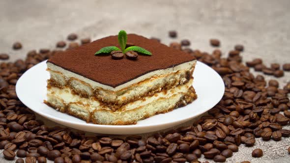 Portion of Traditional Italian Tiramisu dessert and coffee beans