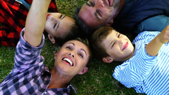 Happy family lying on the grass