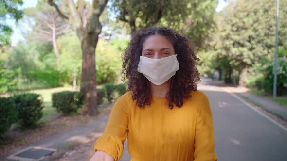 Slow motion shot of woman wearing surgical mask on bike