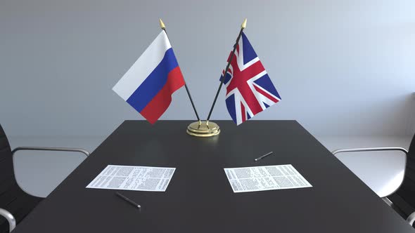 Flags of Russia and the UK on the Table