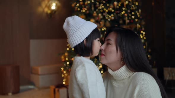 Korean Family Mom and Daughter Child in White Sweater and Knitted Hat Sitting