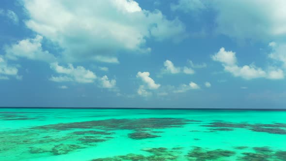 Wide drone island view of a paradise sunny white sand beach and blue ocean background in vibrant 