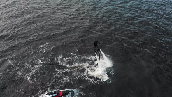 Water Sports  a Man Flying Around Over the Water  Aerial View