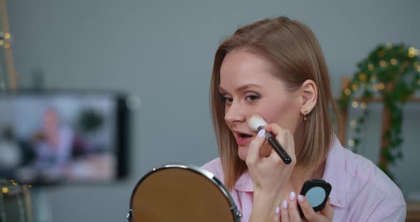 Woman Talking and Using Make Up Brush Applying Pot Rouge While Recording Video for Beauty Vlog