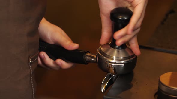 Woman'S Hands Brace And Firmly Press Espresso Tamper Into Portafilter