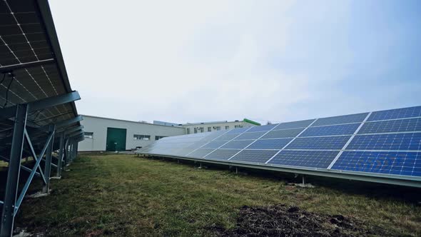 Innovative photovoltaic panels on the field. Sunny batteries on the ground in the modern solar farm.