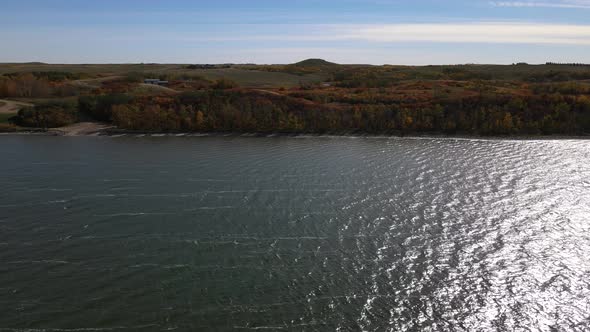 Aerial orbiting cameraement above Buffalo Lake in Alberta during a sunny autumn day. 4k drone footag