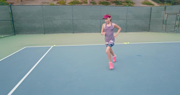 Tennis Player Wearing Purple Dress Running Along the Court