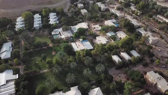 Aerial: drone view over the rooftops of the village of Yotvata, Israel