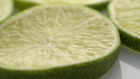 Lime Slices Closeup, Macro Food Summer Background, Fruits Top View. Rotate