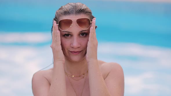 Portrait of a Young Pretty Woman By a Swimming Pool