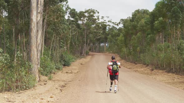 Sporty mixed race man with prosthetic leg hiking