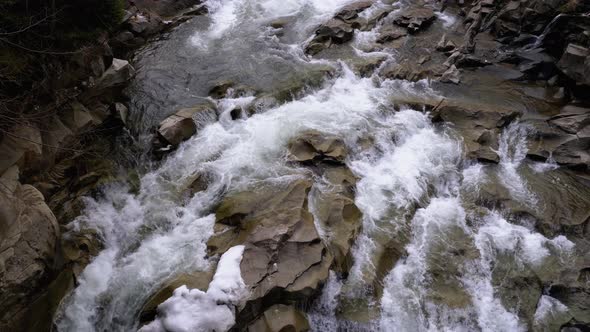 Waterfall Prut in the Winter. Rapid Flow of Water From a Mountain Creek and Stone Rapids with Snow