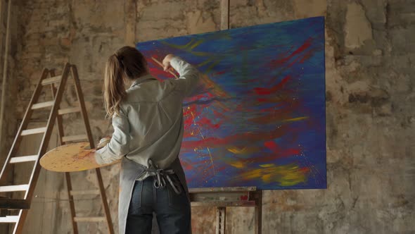 Female Artist Paints a Picture of Her Studio