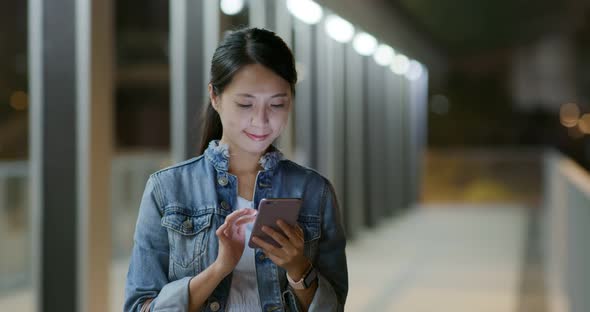 Woman work on cellphone at night