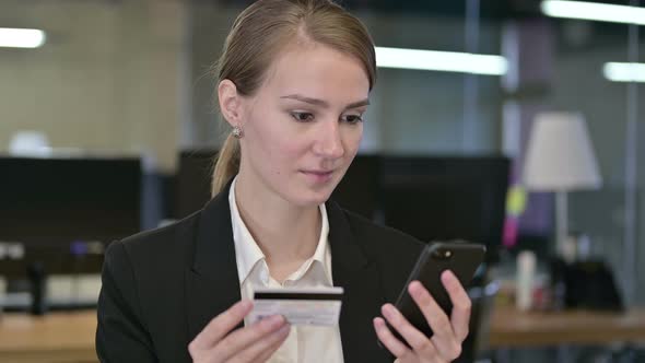 Portrait of Young Businesswoman Making Online Payment on Smartphone