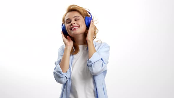 Happy Dancing Woman Enjoying Music in Headphones Music