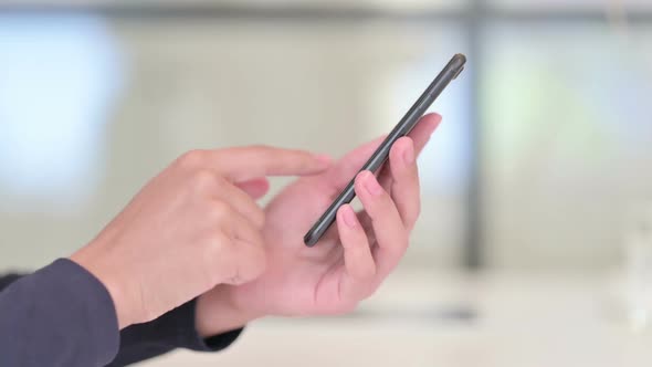 Close Up of Hands of African Woman Using Smartphone