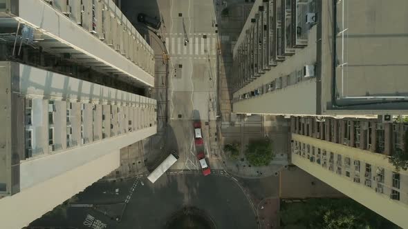 Top View Drone Flies Between and Above Tall Apartment Blocks.